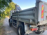 an image of a dump truck parked on the side of the road