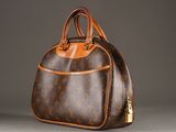 a brown and tan handbag sitting on top of a table