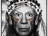 black and white photograph of a native american man wearing a feather headdress