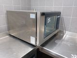 two microwaves sitting on top of each other in a kitchen