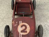 a small red toy car with a number 2 on it