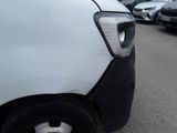 a white van parked in a parking lot with other cars in the background