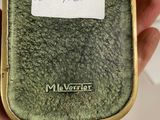 a person holding a green case that has a label on it