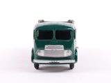 a green toy truck that is sitting on a white surface