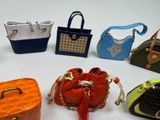 several small purses are lined up on a white surface