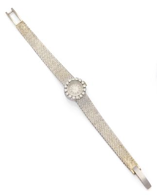 a close up of a wrist watch on a white surface