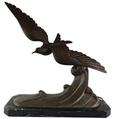 bronze sculpture of a bird on a wave on a marble base