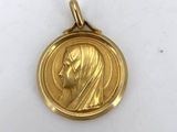 a close up of a gold medal with a woman ' s face on it