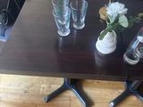 a table with three glasses and a vase on top of it