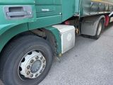 a large green truck parked on the side of the road