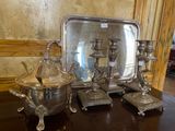 a silver tray with two silver candles and a silver tray with a silver lid