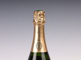 bottles of sparkling wine on a table with a gray background