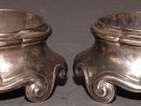 pair of silverplated candlestick holders on a black background