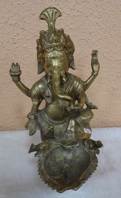 brass statue of an elephant sitting on top of a turtle