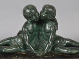statue of two children sitting on a marble base with a gray background