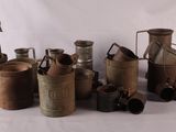 a lot of old metal containers sitting on a table