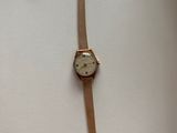 an image of a wrist watch on a white surface with a price tag