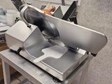 an image of a commercial meat slicer in a kitchen