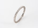 a white gold ring with round diamonds on a white background