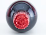 a close up of a wine bottle with a red label