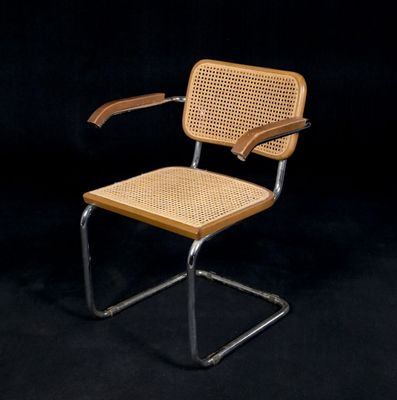 the chair is made of metal and wicker with a wooden seat