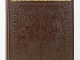 a brown book with gold trimming on the cover