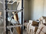 a room filled with boxes and a ladder in the middle of the room