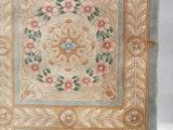 an image of a rug with flowers and leaves on it