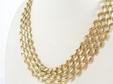 a close up of a gold necklace on a mannequin mannequin