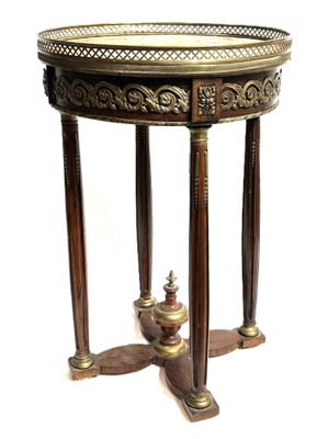 an image of a round table with a metal top and wooden legs
