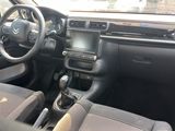 the interior of a car with a steering wheel, dashboard, and dashboard controls