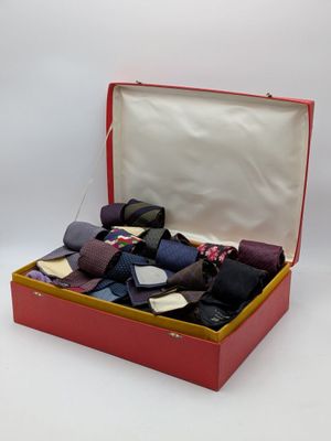 many ties in a red box on a white background