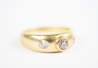 a close up of a gold ring with two diamonds on it