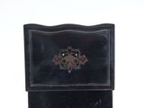 a small black box with a floral design on it