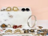 une boîte en marbre blanc sur laquelle sont disposés plusieurs bijoux
