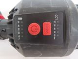 a close up of a red button on a corded corded drill