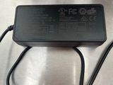 a close up of a charger on a table with a cord
