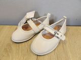 a close up of a pair of white shoes on a wooden surface