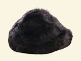 a black cat that is laying down on a white surface