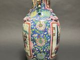 an image of a blue vase with flowers on it on a table
