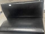 black leather chair with black seat and back rest in a room