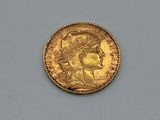 a close up of a gold coin with a woman ' s head on it