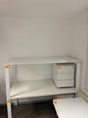 a white desk with a computer on it in a room