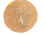 a brown plate with writing on it on a white surface