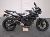 bmw motorcycle parked in a garage with a checkered floor