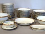 a lot of plates and bowls sitting on a table
