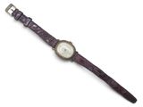 a close up of a watch on a white surface with a white background