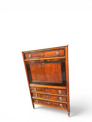 an image of a small wooden cabinet with drawers
