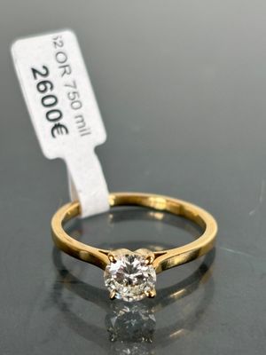 a close up of a diamond ring on a table with a price tag