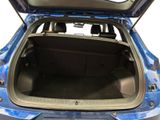 the back of a blue car with its trunk open